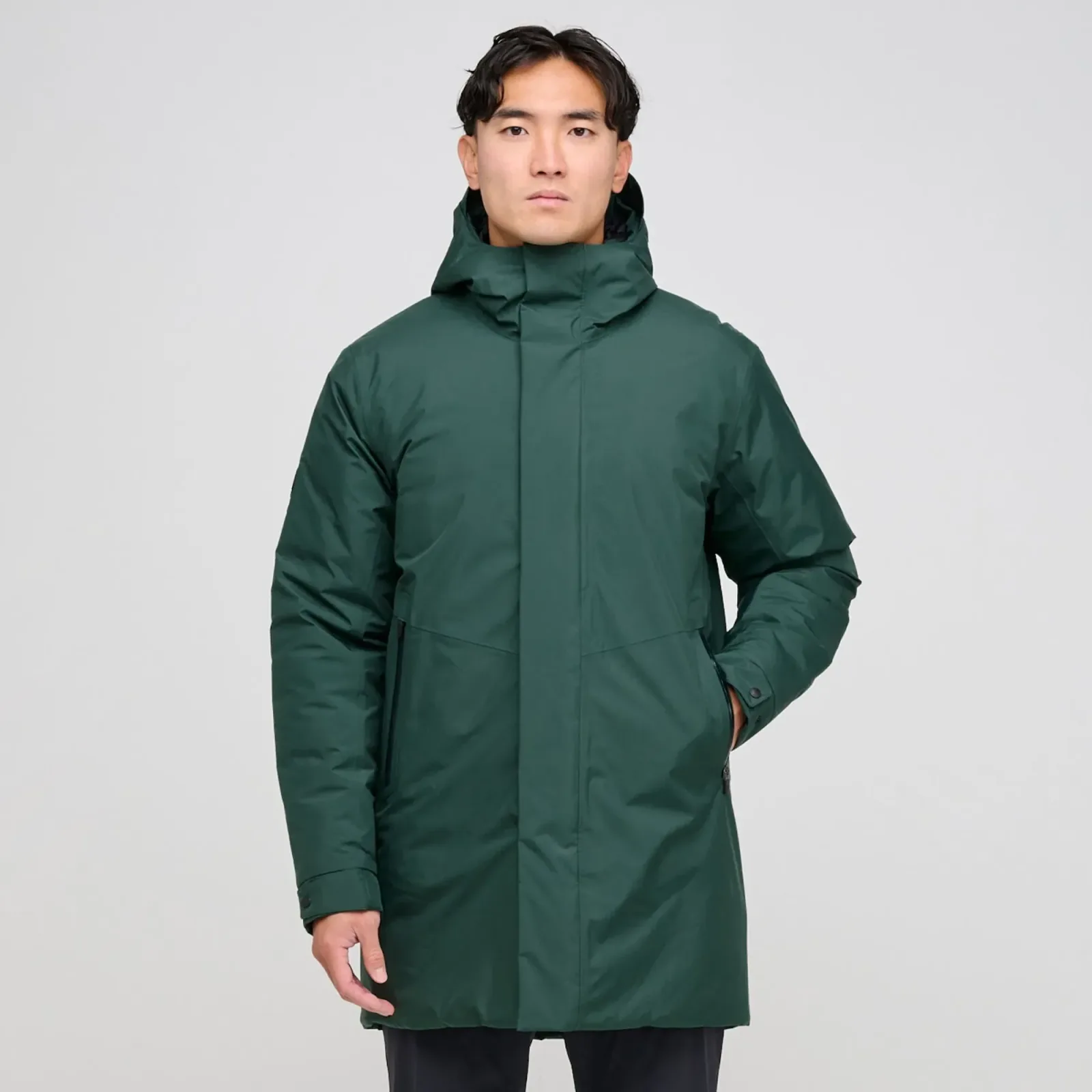 Man in a long jungle green Austin insulated golf parka